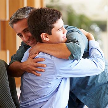 Family Therapy - Picture of a Father Hugging His Son