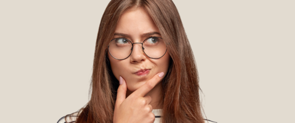 Woman with glasses thinking