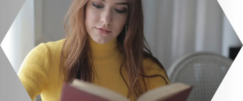 Woman sitting and reading a book